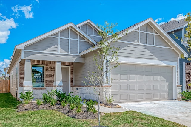 front of property with covered porch, a front yard, and a garage