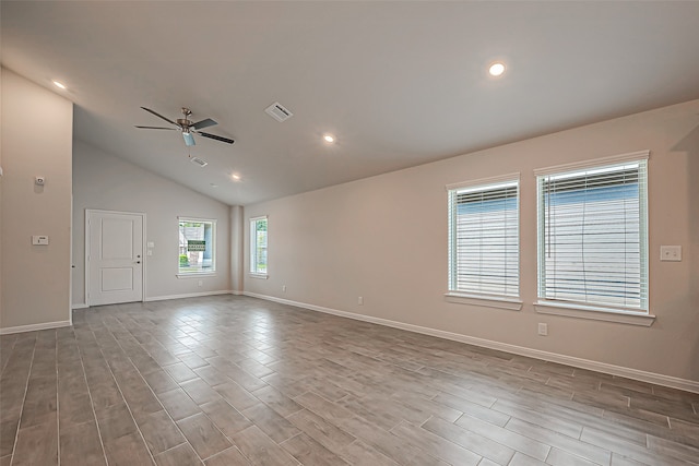 spare room with vaulted ceiling, light hardwood / wood-style flooring, and ceiling fan