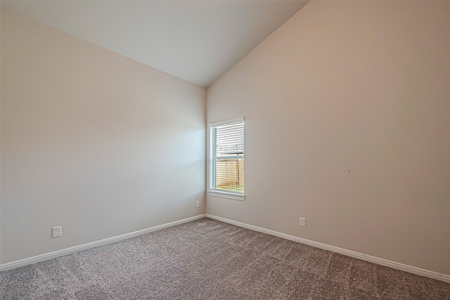 spare room featuring carpet flooring and high vaulted ceiling