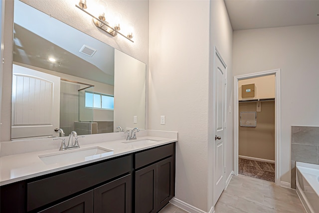 bathroom with independent shower and bath, vanity, lofted ceiling, and tile patterned floors