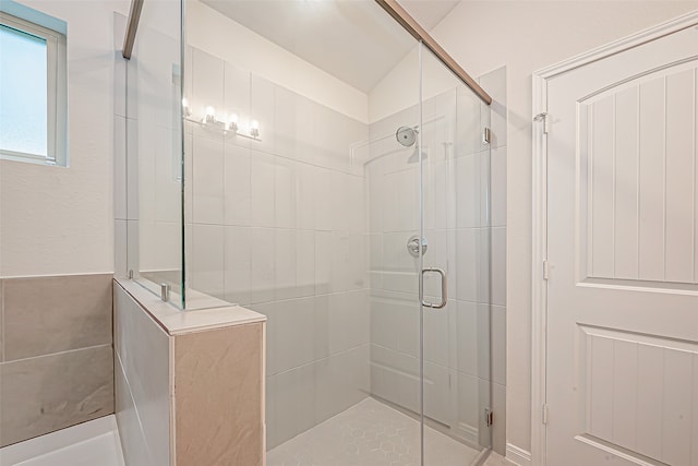 bathroom featuring lofted ceiling and an enclosed shower