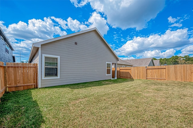 back of property featuring a lawn