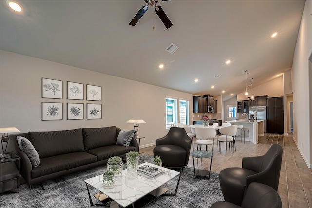 living room featuring ceiling fan, hardwood / wood-style floors, sink, and high vaulted ceiling