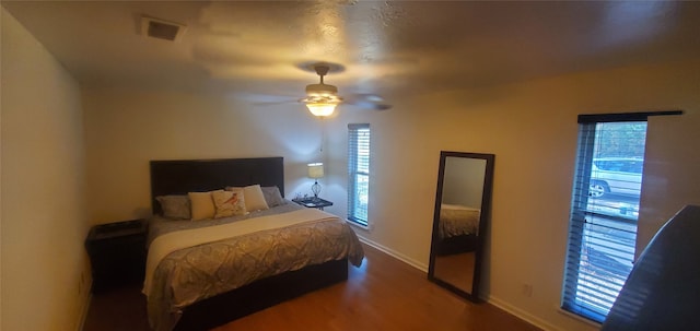 bedroom with ceiling fan and hardwood / wood-style flooring