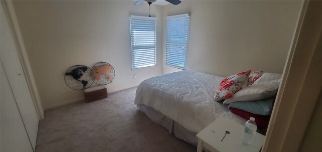 bedroom with ceiling fan and light colored carpet