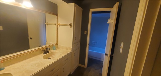 bathroom featuring vanity and a bath