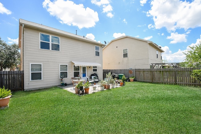 back of house with a yard and a patio area