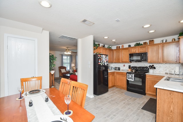 kitchen featuring ceiling fan, a textured ceiling, decorative backsplash, and black appliances