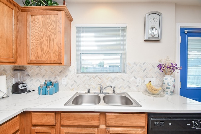 kitchen with dishwasher, tasteful backsplash, and sink