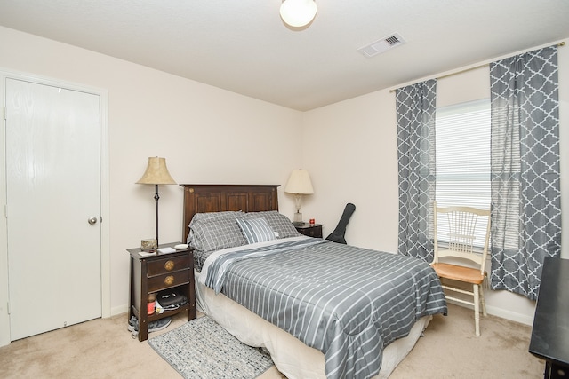 bedroom featuring light carpet