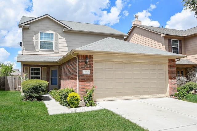 view of front property featuring a front lawn and a garage