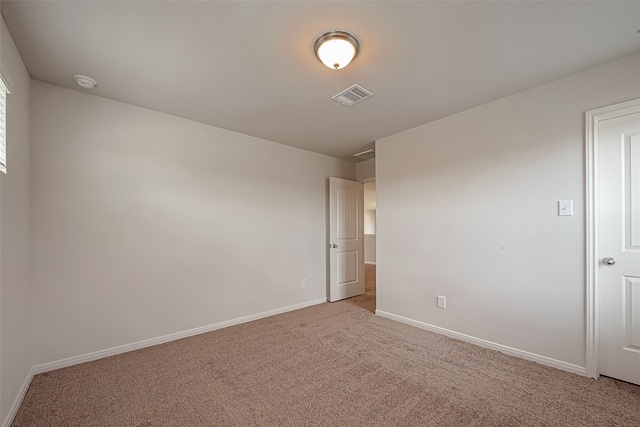 empty room featuring light carpet