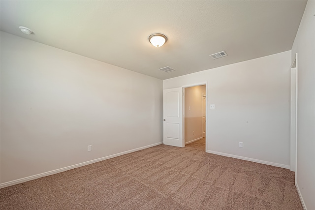 spare room with light colored carpet