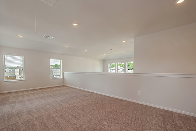 carpeted empty room with plenty of natural light