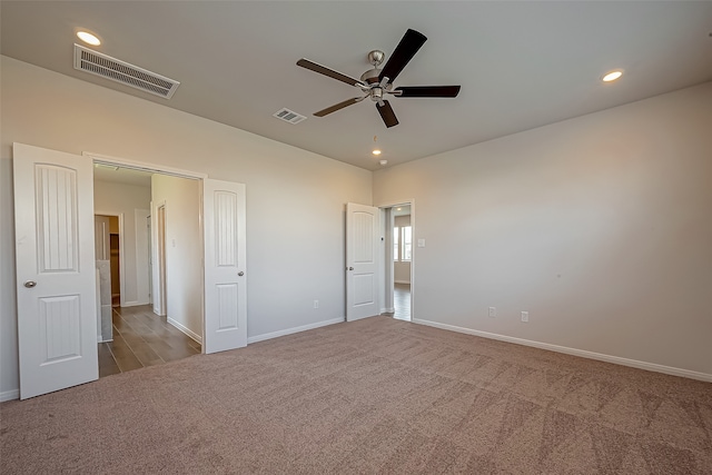 carpeted empty room with ceiling fan