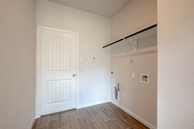 laundry room featuring hookup for a washing machine, gas dryer hookup, dark wood-type flooring, and hookup for an electric dryer