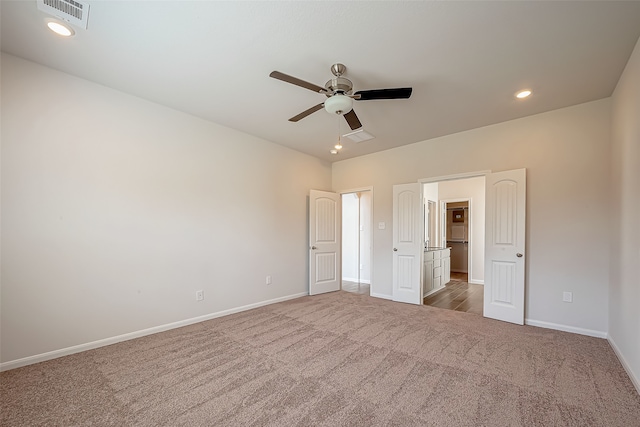 unfurnished bedroom with ceiling fan and dark carpet