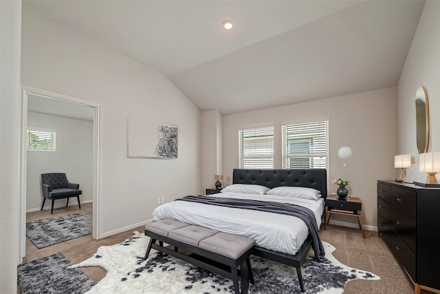 bedroom featuring lofted ceiling and multiple windows