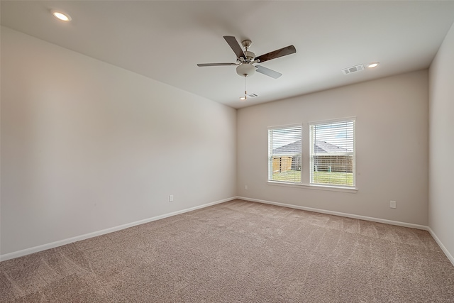 empty room featuring light carpet and ceiling fan