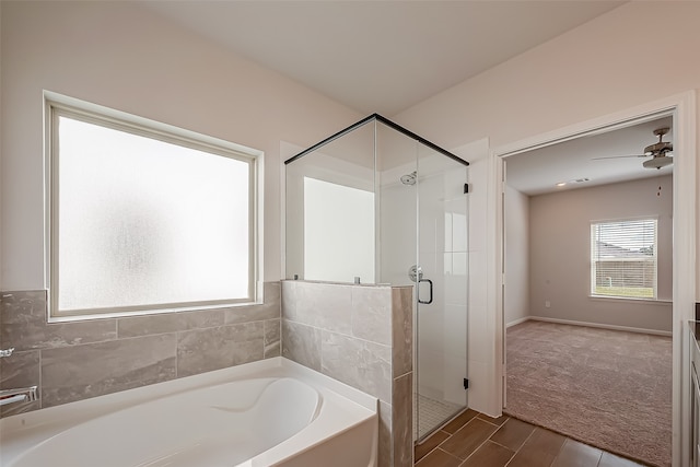 bathroom featuring ceiling fan, separate shower and tub, and hardwood / wood-style flooring