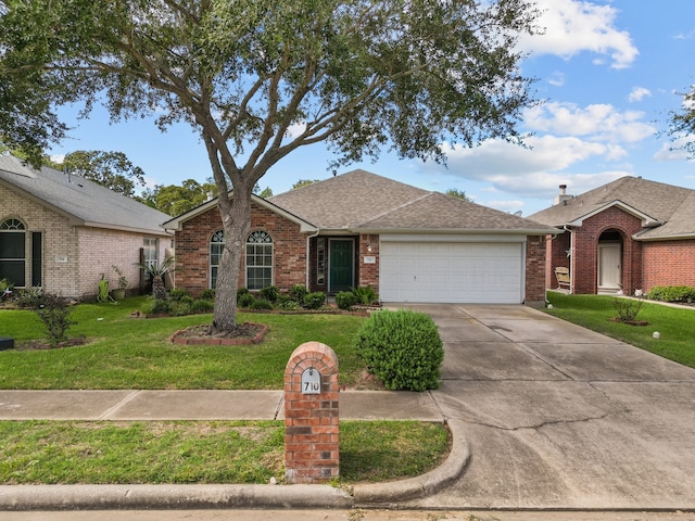 single story home with a garage and a front lawn