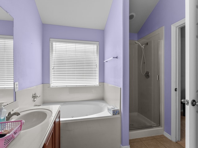 bathroom with vanity, lofted ceiling, separate shower and tub, and tile patterned floors