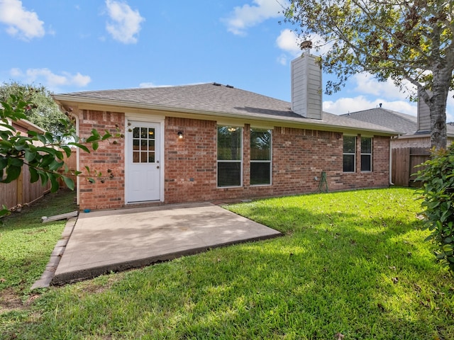 back of house featuring a lawn and a patio area