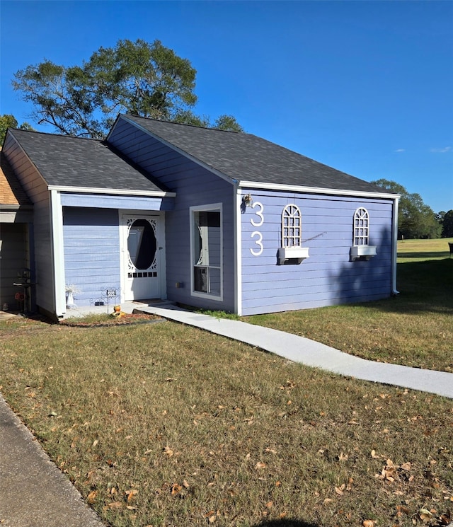 ranch-style house featuring a front yard and a garage