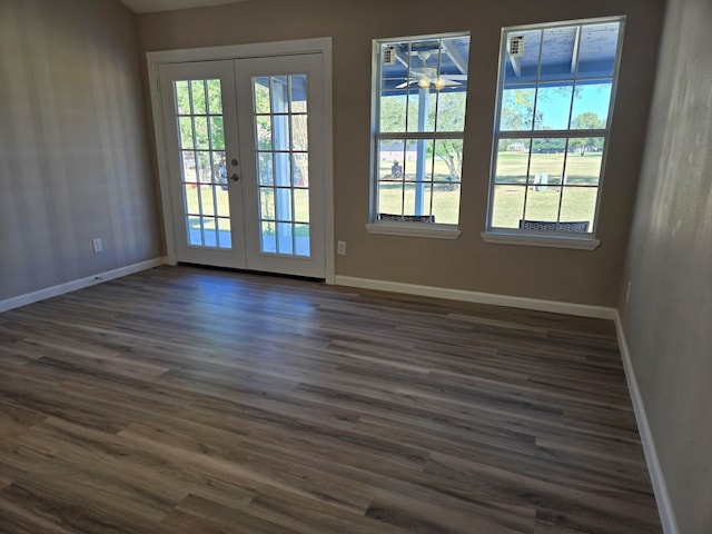 unfurnished room featuring french doors, baseboards, and dark wood finished floors