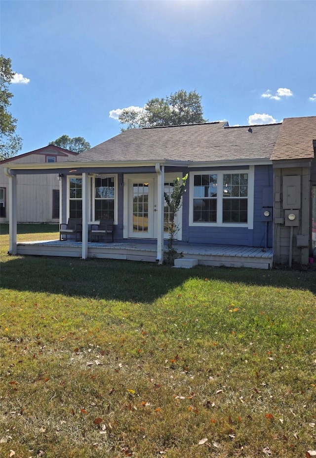 back of property with a lawn