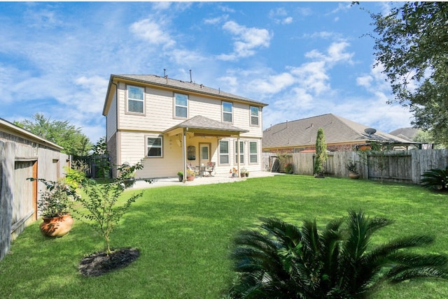 rear view of house with a patio area and a yard