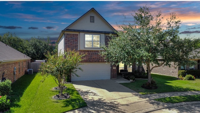 view of front of home with a garage and a yard