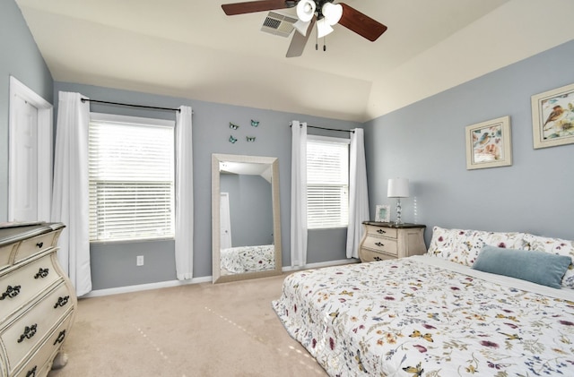 bedroom with lofted ceiling, ceiling fan, and light colored carpet