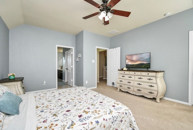 carpeted bedroom with ceiling fan, lofted ceiling, and connected bathroom