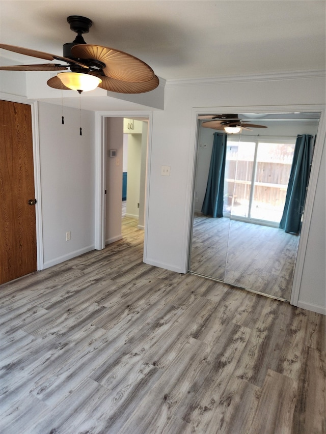 unfurnished room with light hardwood / wood-style floors and crown molding