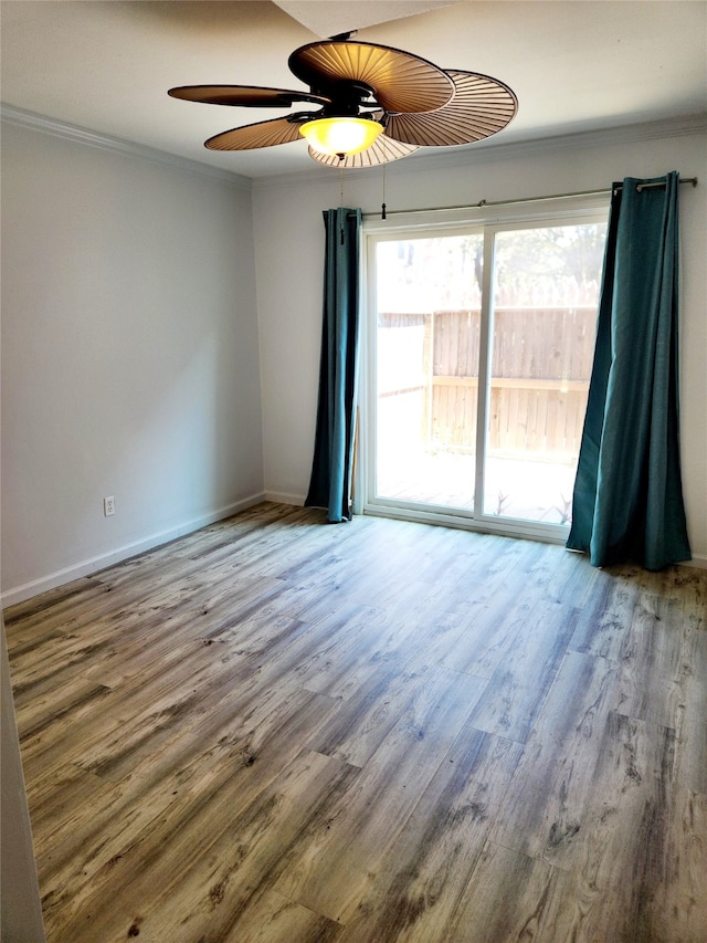 empty room with ornamental molding, hardwood / wood-style floors, and ceiling fan