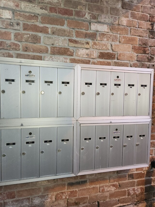 interior space with brick wall and mail boxes