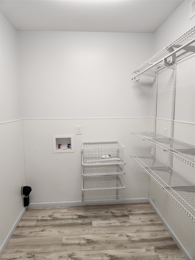 washroom featuring light hardwood / wood-style flooring and hookup for a washing machine