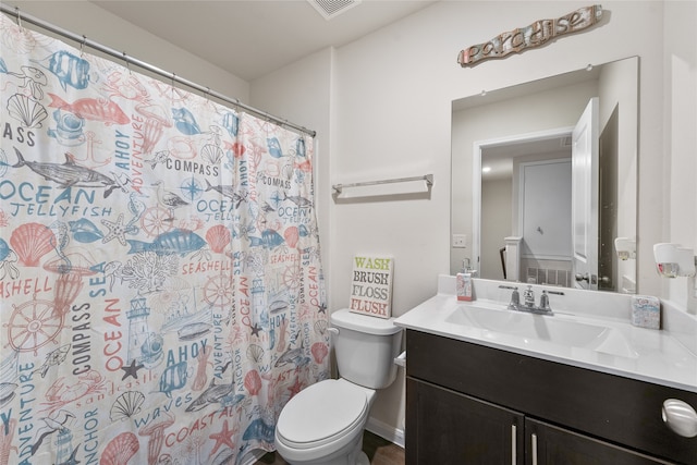 bathroom with vanity, toilet, and curtained shower