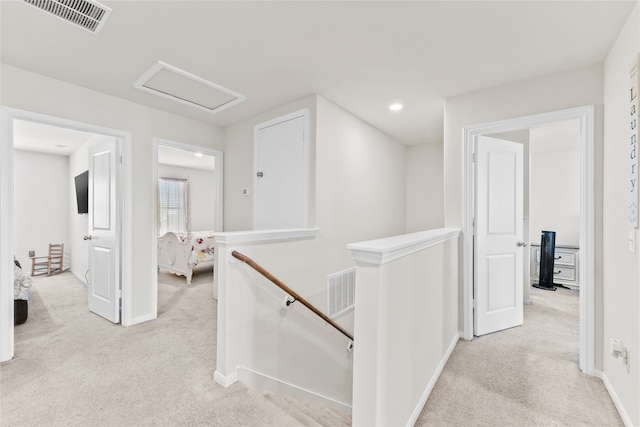 hallway with light colored carpet