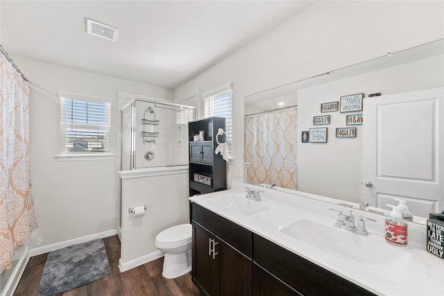 bathroom with a shower with curtain, vanity, hardwood / wood-style floors, and toilet