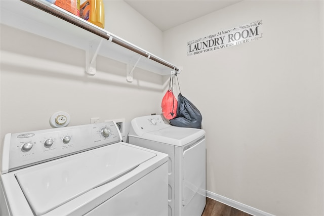 laundry room featuring washer and dryer and dark hardwood / wood-style flooring