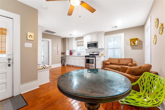 dining room with wood-type flooring and ceiling fan