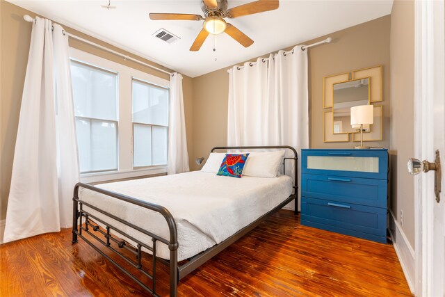 bedroom with ceiling fan and hardwood / wood-style flooring