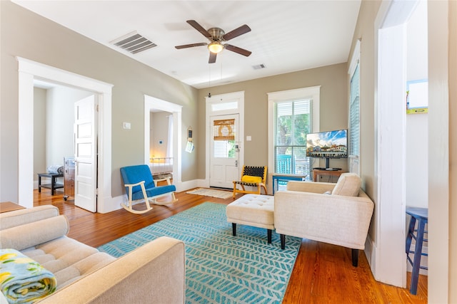 living room featuring ceiling fan and hardwood / wood-style floors