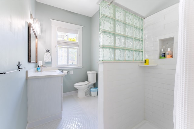 bathroom with tile patterned floors, a shower with curtain, vanity, and toilet