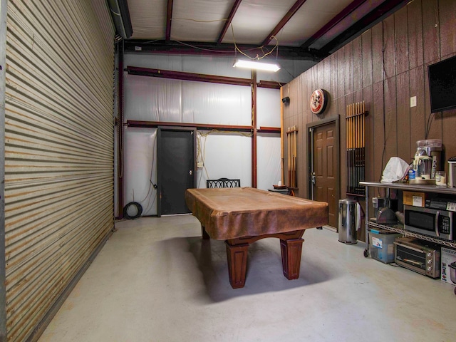 rec room featuring wooden walls, pool table, and vaulted ceiling