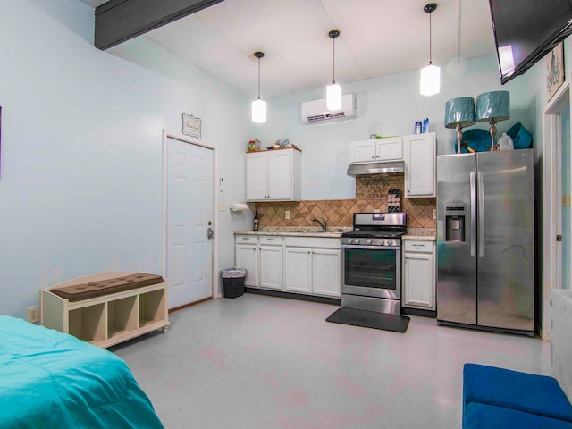 kitchen featuring decorative light fixtures, stainless steel appliances, white cabinets, and a wall unit AC