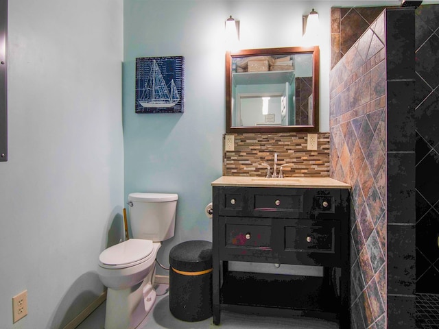 bathroom with vanity, a shower, toilet, and tasteful backsplash