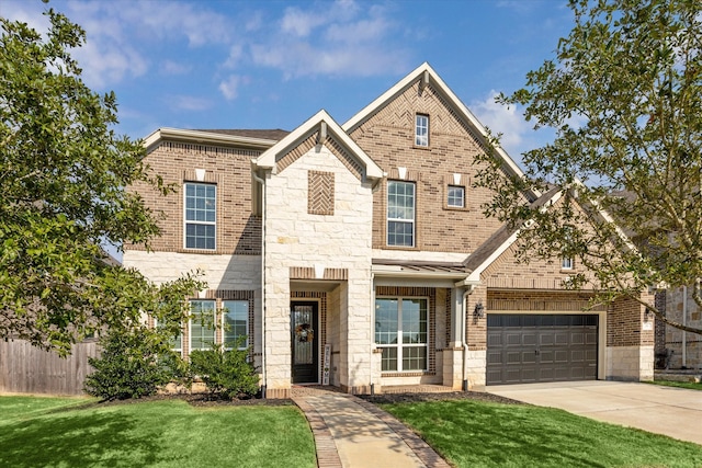 view of front of property with a garage and a front lawn